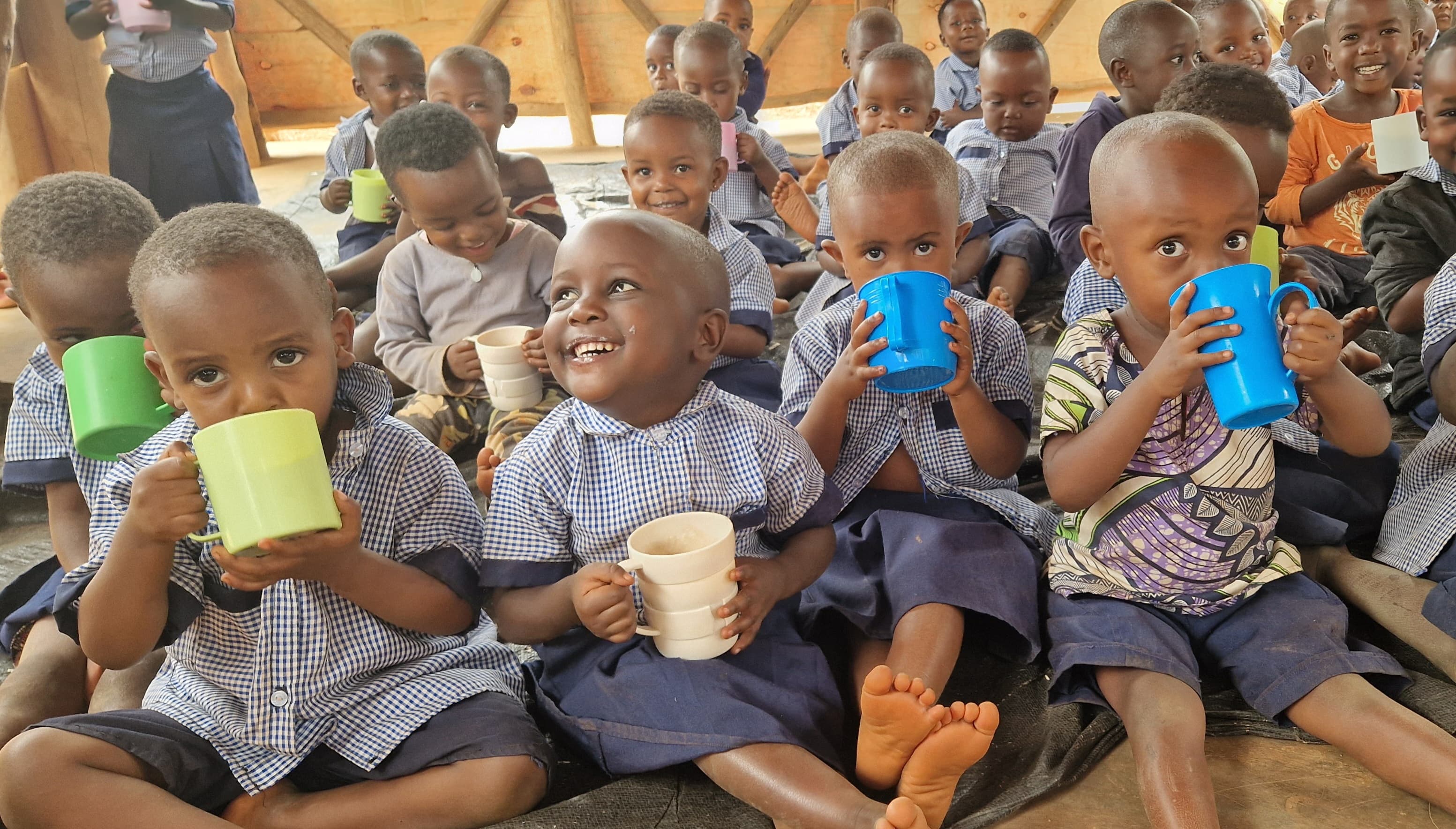 Children sharing a warm meal of porridge together